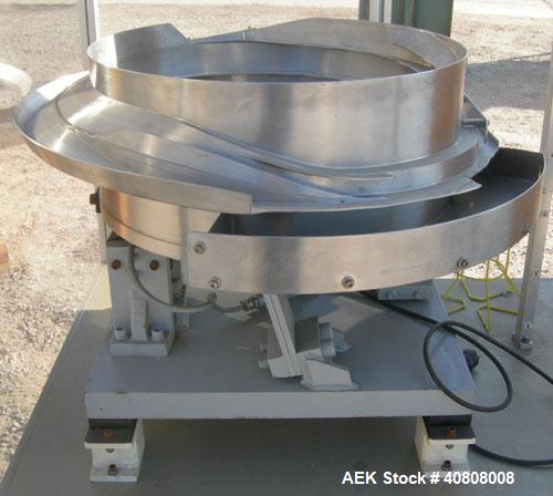 Used Vibratory Parts Feeder, 304 stainless steel. 20'' diameter x 9'' deep feed pan. Mounted on a 23'' tall table.