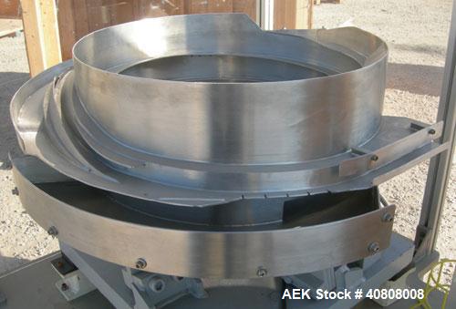 Used Vibratory Parts Feeder, 304 stainless steel. 20'' diameter x 9'' deep feed pan. Mounted on a 23'' tall table.