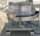 Used Vibratory Parts Feeder, 304 stainless steel. 20'' diameter x 9'' deep feed pan. Mounted on a 23'' tall table.