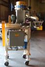 Used Robey Packaging Equipment Auger Bag Filler, Model SA 25.Designed as an auger valve bag packerwith a right angle discharge down spoutand bag clamps for open mouth bag filling.Foot pedal swithced ...