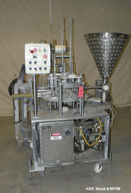 Used Autoprod Cup Filler, Model RO-A3, 8 station, stainless steel. Currently set up for 4-1/4" diameter cups. Jacketed stainless steel hopper. Includes change parts, film die cut station, cup feed st...