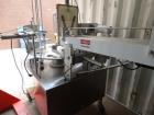 Used World Cup Packaging 8-80 Cup Filler. Container size: up to 80 ounces or up to 6.5 inch maximum diameter with change parts from the OEM. Filling speed: up to 40 indexes per minute depending on cu...