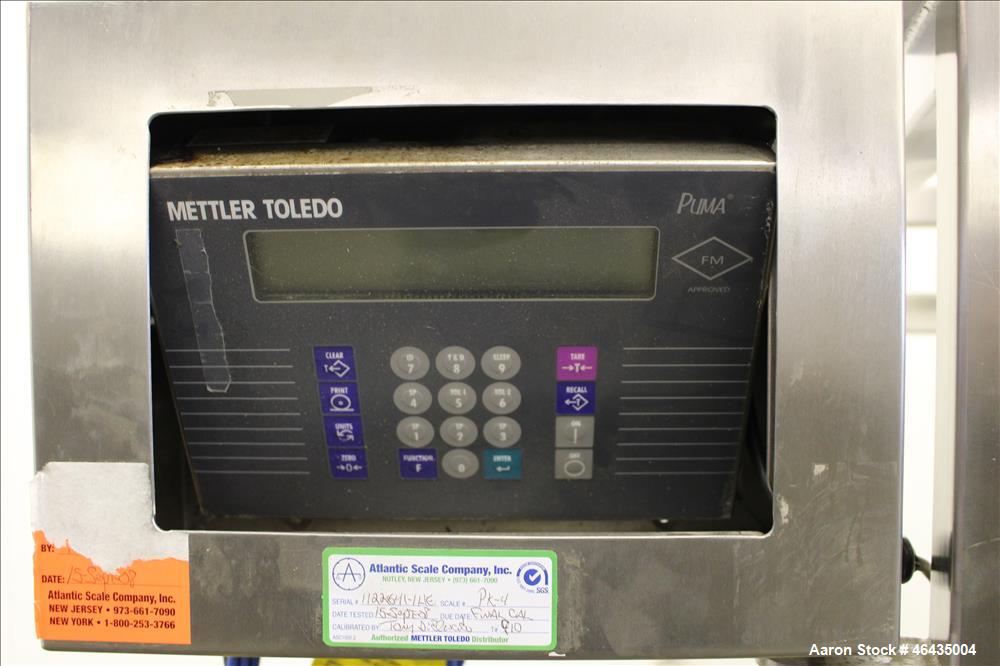 Used Extract Technology Pack-Off Isolator. 10" Diameter filling head with 20-3/4" diameter cone sealing head. Top pneumatic butterfly valve. Side infeed. Has mettler Toledo scale 24" x 30" platform. ...