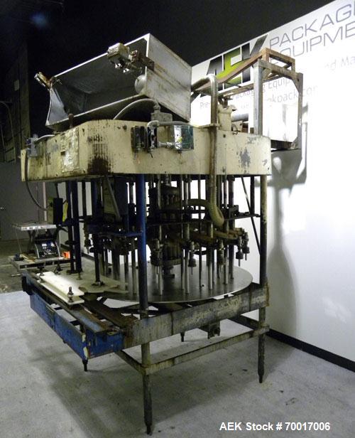 Used Biner-Ellison 18 Head Rotary Gravity/Pressure Filler, Model F-52-TDP-18. Has 1/2" diameter 316 stainless steel nozzles on 8-1/4" centers. Top mounted stainless steel supply tank, recirculation p...