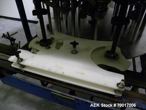Used Biner-Ellison 18 Head Rotary Gravity/Pressure Filler, Model F-52-TDP-18. Has 1/2" diameter 316 stainless steel nozzles on 8-1/4" centers. Top mounted stainless steel supply tank, recirculation p...