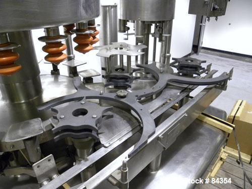 Used Federal Rotary Gravity Filler, Model GWS3/155R1092, 304 Stainless Steel. (15) 1" diameter nozzles on approximate 7-1/2" centers. Set up with a 5 head press-on rotary capper (requires sorter and ...