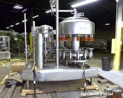 Used Federal Rotary Gravity Filler, Model GWS3/155R1092, 304 Stainless Steel. (15) 1" diameter nozzles on approximate 7-1/2" centers. Set up with a 5 head press-on rotary capper (requires sorter and ...