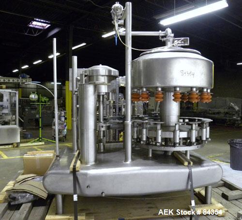 Used Federal Rotary Gravity Filler, Model GWS3/155R1092, 304 Stainless Steel. (15) 1" diameter nozzles on approximate 7-1/2" centers. Set up with a 5 head press-on rotary capper (requires sorter and ...