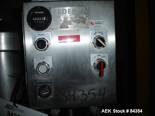 Used Federal Rotary Gravity Filler, Model GWS3/155R1092, 304 Stainless Steel. (15) 1" diameter nozzles on approximate 7-1/2" centers. Set up with a 5 head press-on rotary capper (requires sorter and ...