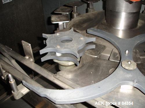 Used Federal Rotary Gravity Filler, Model GWS3/155R1092, 304 Stainless Steel. (15) 1" diameter nozzles on approximate 7-1/2" centers. Set up with a 5 head press-on rotary capper (requires sorter and ...