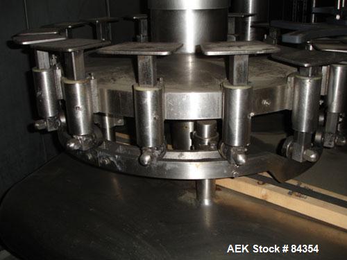 Used Federal Rotary Gravity Filler, Model GWS3/155R1092, 304 Stainless Steel. (15) 1" diameter nozzles on approximate 7-1/2" centers. Set up with a 5 head press-on rotary capper (requires sorter and ...