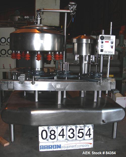 Used Federal Rotary Gravity Filler, Model GWS3/155R1092, 304 Stainless Steel. (15) 1" diameter nozzles on approximate 7-1/2" centers. Set up with a 5 head press-on rotary capper (requires sorter and ...
