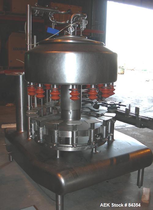 Used Federal Rotary Gravity Filler, Model GWS3/155R1092, 304 Stainless Steel. (15) 1" diameter nozzles on approximate 7-1/2" centers. Set up with a 5 head press-on rotary capper (requires sorter and ...