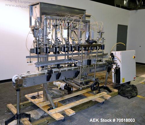 Used Fluid Packaging Solutions 12 Head Inline Automatic Time / Gravity Liquid Filler. Fabricated with 4-1/2" wide x 180" long table top chain conveyor, 5/8" nozzles with positive shut-off valves, div...
