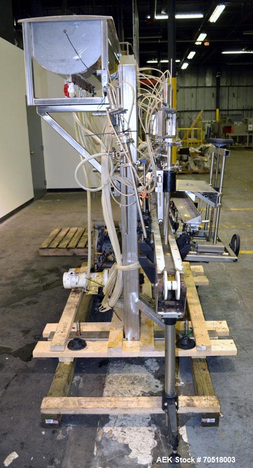 Used Fluid Packaging Solutions 12 Head Inline Automatic Time / Gravity Liquid Filler. Fabricated with 4-1/2" wide x 180" long table top chain conveyor, 5/8" nozzles with positive shut-off valves, div...