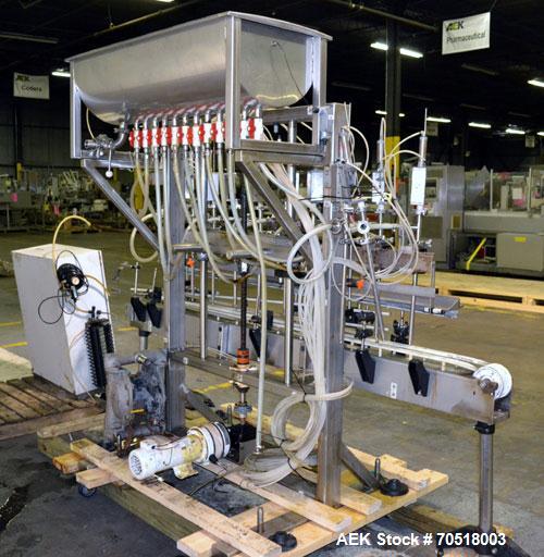 Used Fluid Packaging Solutions 12 Head Inline Automatic Time / Gravity Liquid Filler. Fabricated with 4-1/2" wide x 180" long table top chain conveyor, 5/8" nozzles with positive shut-off valves, div...