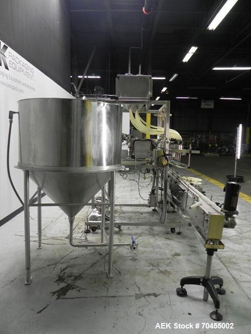 Used Inline Filling Systems 12 head inline time gravity filler. Capable of speeds over 100 bottle per minute. Has star wheel indexing system, neck guides, drip tray, and 12 'long x 4-1/2" wide convey...