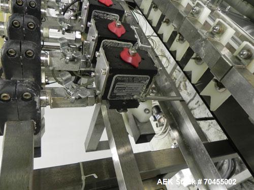 Used Inline Filling Systems 12 head inline time gravity filler. Capable of speeds over 100 bottle per minute. Has star wheel indexing system, neck guides, drip tray, and 12 'long x 4-1/2" wide convey...