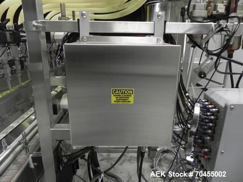 Used Inline Filling Systems 12 head inline time gravity filler. Capable of speeds over 100 bottle per minute. Has star wheel indexing system, neck guides, drip tray, and 12 'long x 4-1/2" wide convey...