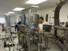Used Equipment Express 8 Head Gravity Overflow Filler. Stainless Steel With Conveyor & Recirculation Pump