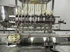 Used Inline Filling Systems 12 head inline time gravity filler. Capable of speeds over 100 bottle per minute. Has star wheel indexing system, neck guides, drip tray, and 12 'long x 4-1/2