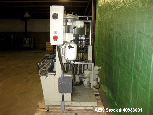 Used Seitz (KHS Filling) Monoblock 12 Head Rotary Wine Filler and Corker. Capable of speeds up to 60 BPM. Has 5/8" diameter nozzles on 6-3/8" centers. Complete with platform base, vacuum pump, star t...