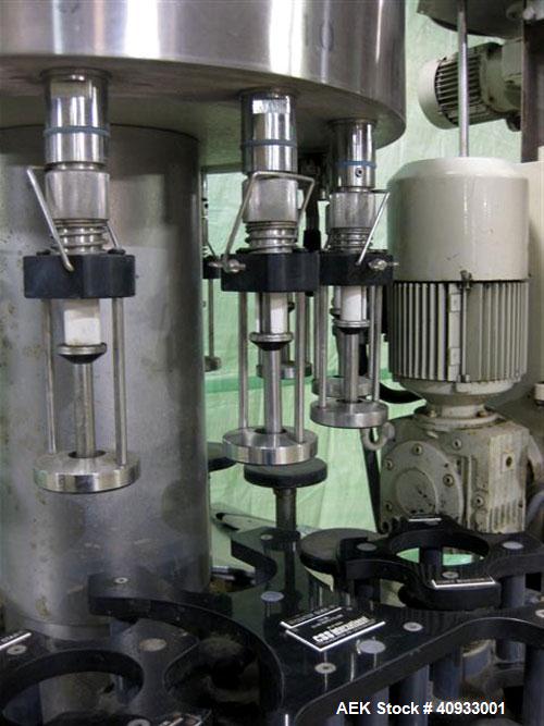 Used Seitz (KHS Filling) Monoblock 12 Head Rotary Wine Filler and Corker. Capable of speeds up to 60 BPM. Has 5/8" diameter nozzles on 6-3/8" centers. Complete with platform base, vacuum pump, star t...
