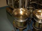 Used Comas model FD120 monoblock filler, stopper and aluminum crimper. Unit dose filler, barrel syringe bowl feeder, dual lanes, two smaller bowls for over cap. Last used for topical, ceramic ivac pu...