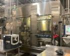 Used Serac Net Weight Rotary Monobloc Liquid Filler, Model 18/6. Has 18 filling nozzles set on a stainless steel turret and 6 cap stations. Has color touchscreen operator HMI and Allen Bradley PLC co...