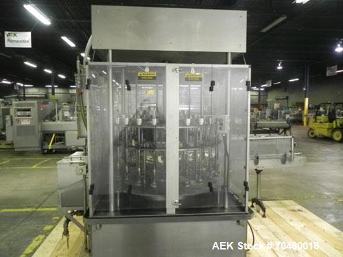 Used MRM Elgin 24 Head Rotary Gravity Overflow Filler. Capable of speeds up to 130 containers per minute. Machine is set on 6" centers with centering belts and 3/16" diameter nozzles. Screw conveyor ...