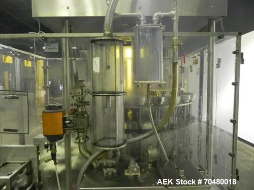 Used MRM Elgin 24 Head Rotary Gravity Overflow Filler. Capable of speeds up to 130 containers per minute. Machine is set on 6" centers with centering belts and 3/16" diameter nozzles. Screw conveyor ...