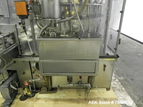 Used MRM Elgin 24 Head Rotary Gravity Overflow Filler. Capable of speeds up to 130 containers per minute. Machine is set on 6" centers with centering belts and 3/16" diameter nozzles. Screw conveyor ...