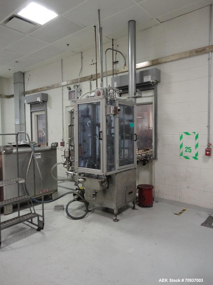 Used MRM 8 Head Rotary Vacuum Filler, speeds up to 100 bottles per minute maximum, vacuum jar, explosion proof design, stainless steel and Lexan guards.

