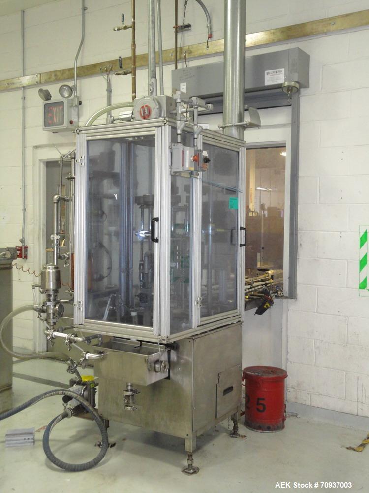 Used MRM 8 Head Rotary Vacuum Filler, speeds up to 100 bottles per minute maximum, vacuum jar, explosion proof design, stainless steel and Lexan guards.

