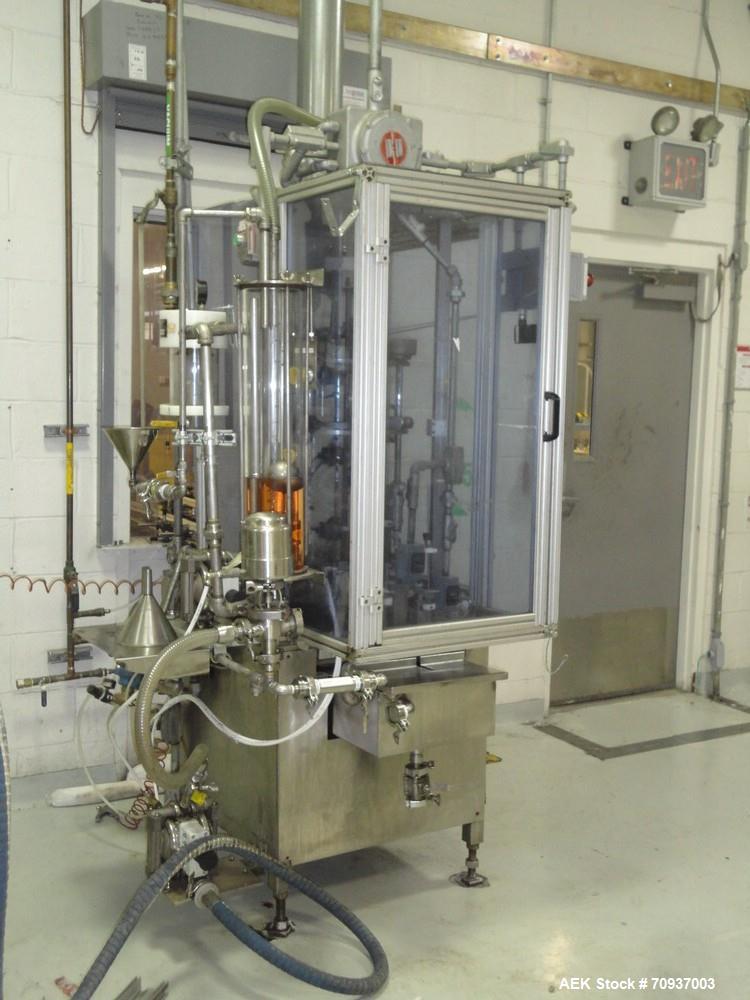 Used MRM 8 Head Rotary Vacuum Filler, speeds up to 100 bottles per minute maximum, vacuum jar, explosion proof design, stainless steel and Lexan guards.

