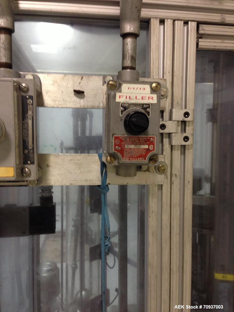 Used MRM 8 Head Rotary Vacuum Filler, speeds up to 100 bottles per minute maximum, vacuum jar, explosion proof design, stainless steel and Lexan guards.

