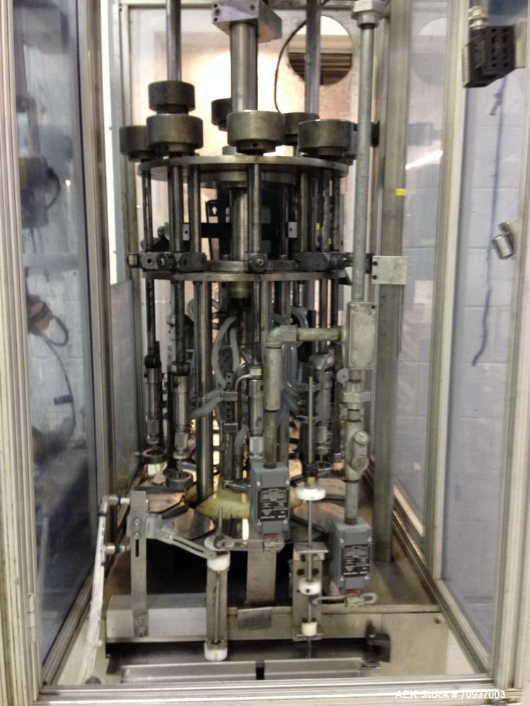 Used MRM 8 Head Rotary Vacuum Filler, speeds up to 100 bottles per minute maximum, vacuum jar, explosion proof design, stainless steel and Lexan guards.

