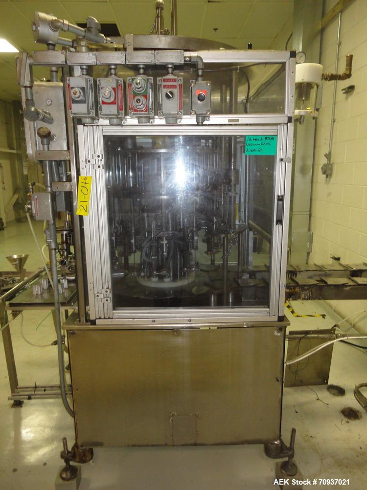 Used RJM 12 Head Rotary Vacuum Filler, explosion proof, vacuum jar, stainless steel and lexan guards, stainless steel supply tank. Pocket filler design (no container handling parts).