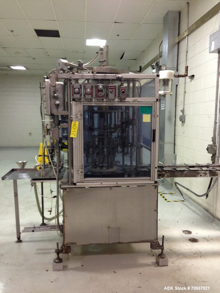 Used RJM 12 Head Rotary Vacuum Filler, explosion proof, vacuum jar, stainless steel and lexan guards, stainless steel supply tank. Pocket filler design (no container handling parts).