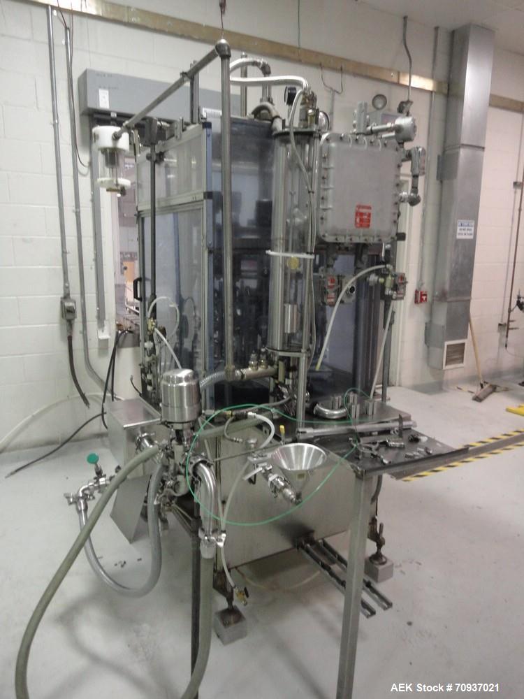 Used RJM 12 Head Rotary Vacuum Filler, explosion proof, vacuum jar, stainless steel and lexan guards, stainless steel supply tank. Pocket filler design (no container handling parts).