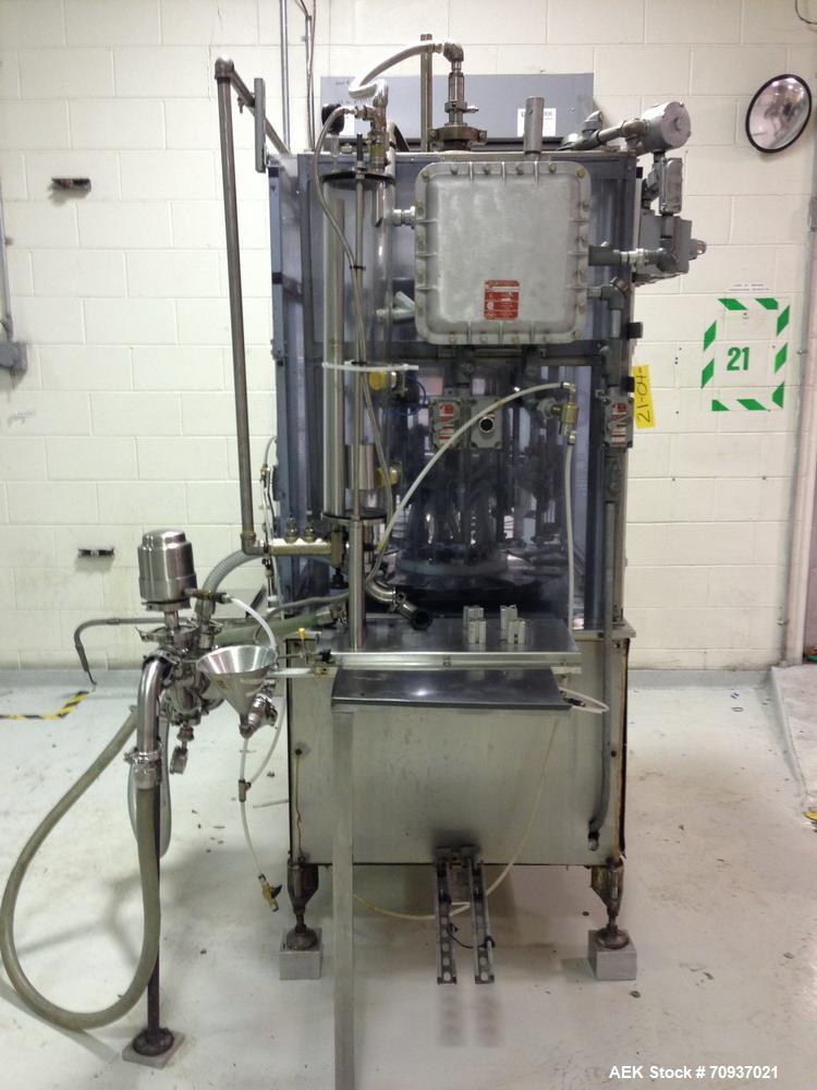 Used RJM 12 Head Rotary Vacuum Filler, explosion proof, vacuum jar, stainless steel and lexan guards, stainless steel supply tank. Pocket filler design (no container handling parts).