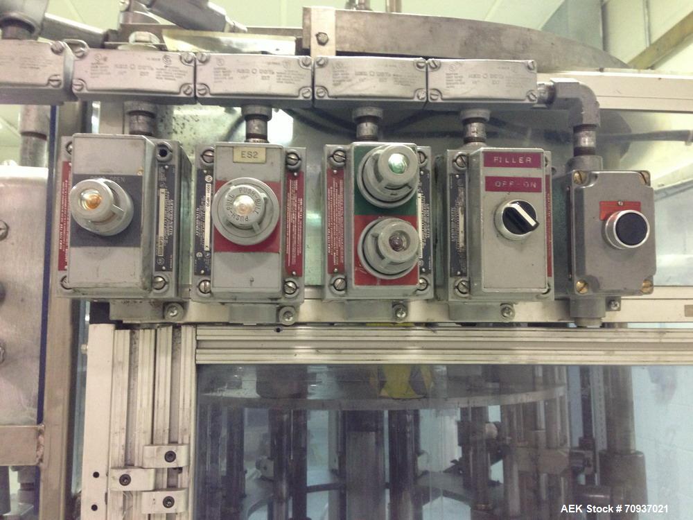 Used RJM 12 Head Rotary Vacuum Filler, explosion proof, vacuum jar, stainless steel and lexan guards, stainless steel supply tank. Pocket filler design (no container handling parts).