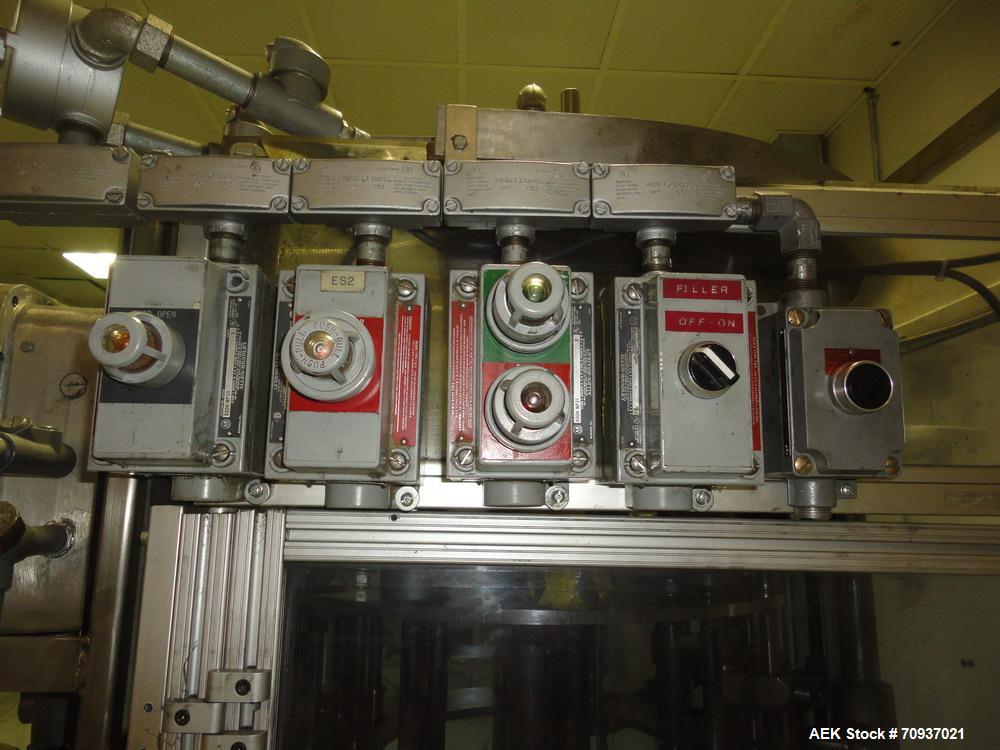 Used RJM 12 Head Rotary Vacuum Filler, explosion proof, vacuum jar, stainless steel and lexan guards, stainless steel supply tank. Pocket filler design (no container handling parts).