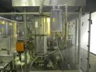 Used MRM Elgin 24 Head Rotary Gravity Overflow Filler. Capable of speeds up to 130 containers per minute. Machine is set on 6