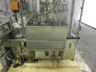 Used MRM Elgin 24 Head Rotary Gravity Overflow Filler. Capable of speeds up to 130 containers per minute. Machine is set on 6