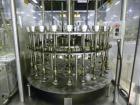 Used MRM Elgin 24 Head Rotary Gravity Overflow Filler. Capable of speeds up to 130 containers per minute. Machine is set on 6