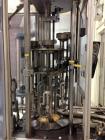 Used MRM 8 Head Rotary Vacuum Filler, speeds up to 100 bottles per minute maximum, vacuum jar, explosion proof design, stainless steel and Lexan guards.

