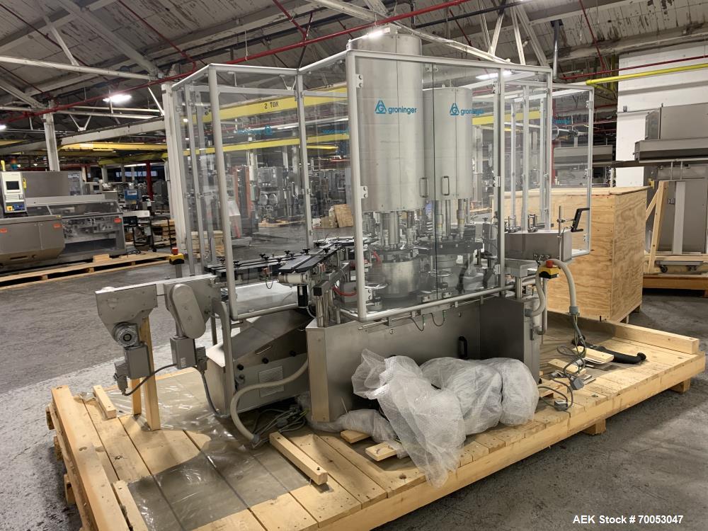 Used Used Groninger inserter capper, Model KVK 206, speeds up to 10000 BPH(166 BPM), with (2) 6 head stations, currently set up with (6) head dropper inserter, and (6) head capper stations, 30 - 230 ...