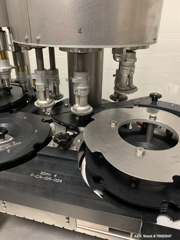 Used Used Groninger inserter capper, Model KVK 206, speeds up to 10000 BPH(166 BPM), with (2) 6 head stations, currently set up with (6) head dropper inserter, and (6) head capper stations, 30 - 230 ...