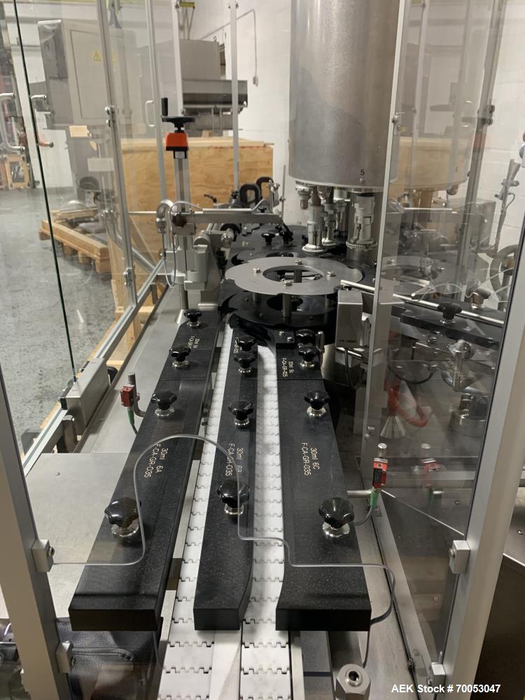 Used Used Groninger inserter capper, Model KVK 206, speeds up to 10000 BPH(166 BPM), with (2) 6 head stations, currently set up with (6) head dropper inserter, and (6) head capper stations, 30 - 230 ...